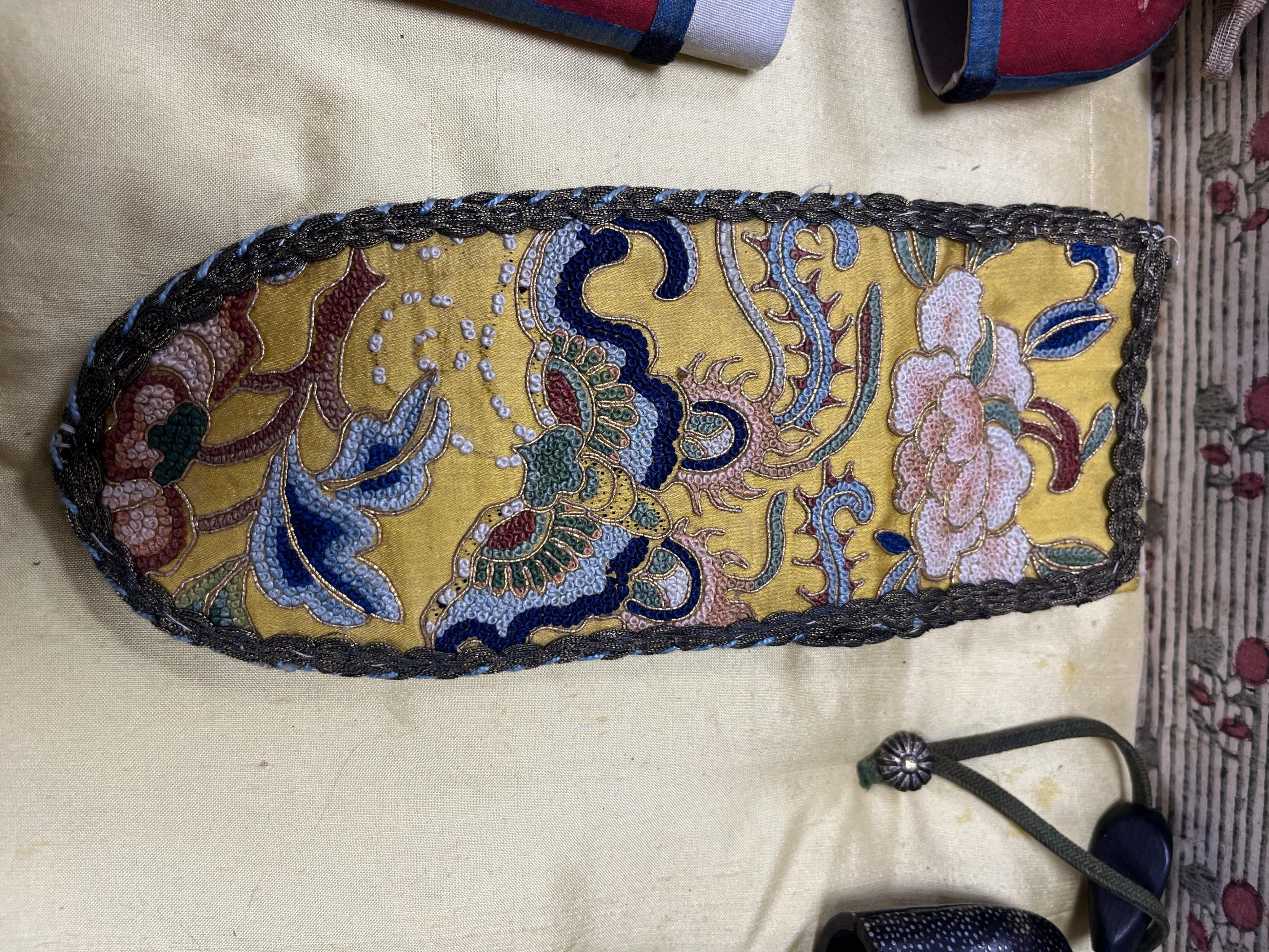 A collection of 19th/20th century Chinese embroidered silk spectacle cases and various spectacles, Box 33cm square